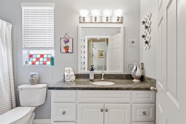 bathroom with vanity, a wealth of natural light, and toilet