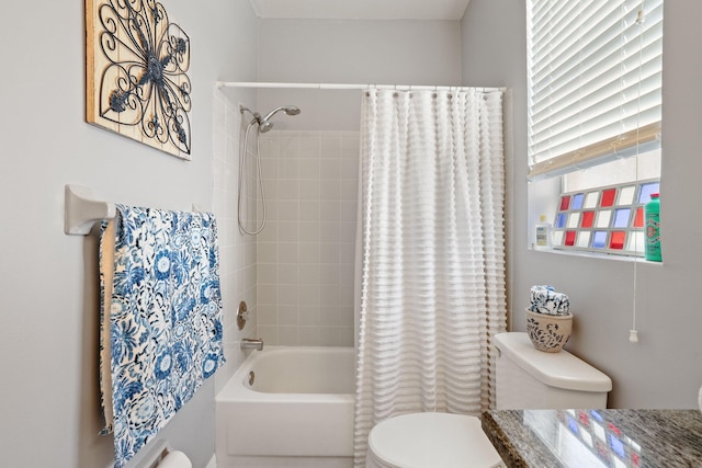 full bathroom with vanity, shower / tub combo with curtain, and toilet