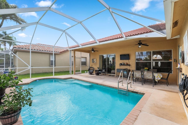 view of pool with a lanai, a patio area, and ceiling fan