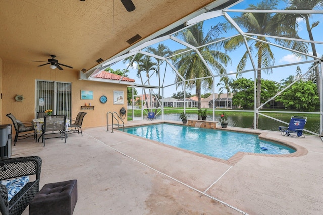 view of swimming pool featuring a patio, pool water feature, ceiling fan, and glass enclosure