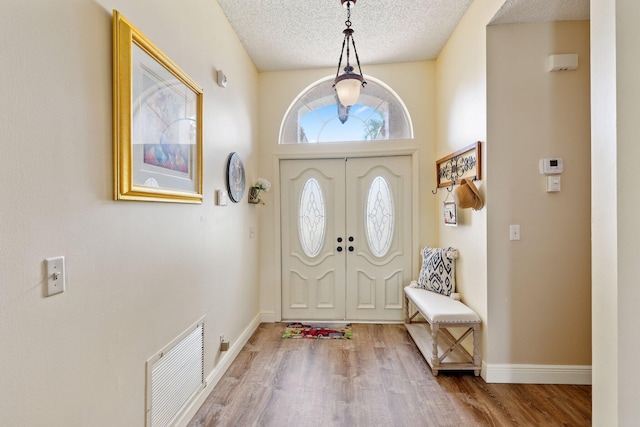 foyer featuring hardwood / wood-style flooring and a textured ceiling