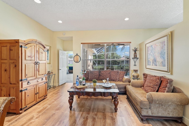 living room featuring light hardwood / wood-style flooring and a textured ceiling