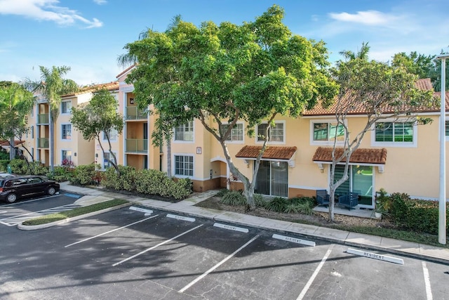 view of property with uncovered parking