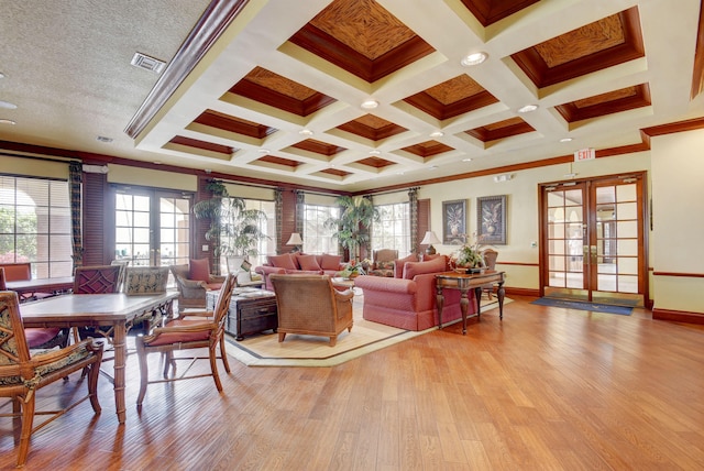 living room with beam ceiling, light hardwood / wood-style flooring, french doors, and coffered ceiling