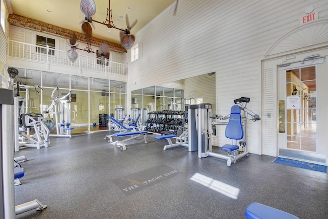 exercise room with a high ceiling