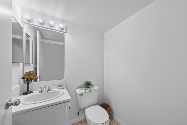 bathroom featuring vanity, tile patterned flooring, and toilet