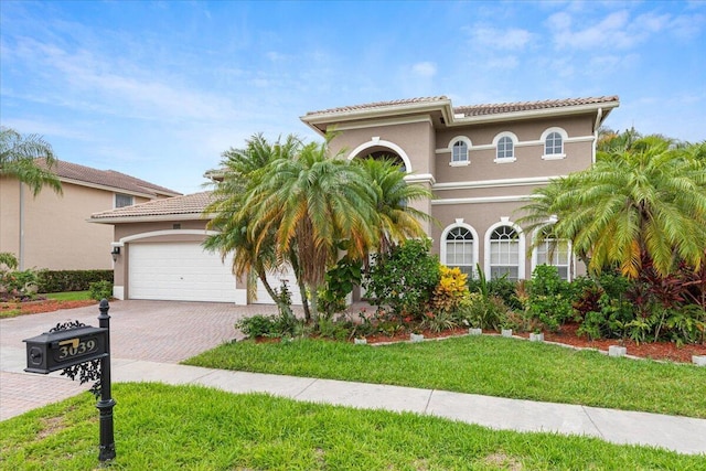 mediterranean / spanish home with a front lawn