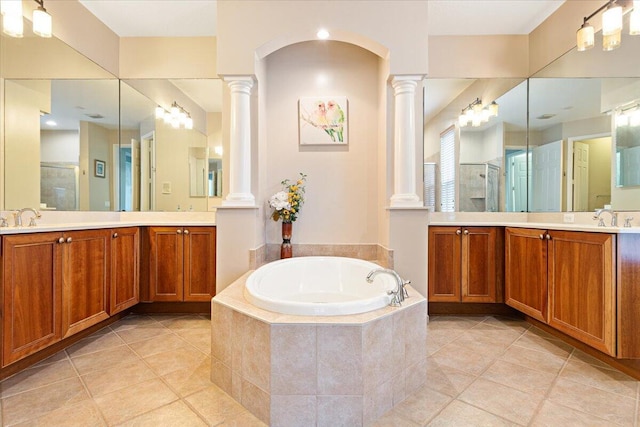 bathroom featuring tile patterned flooring, vanity, and shower with separate bathtub