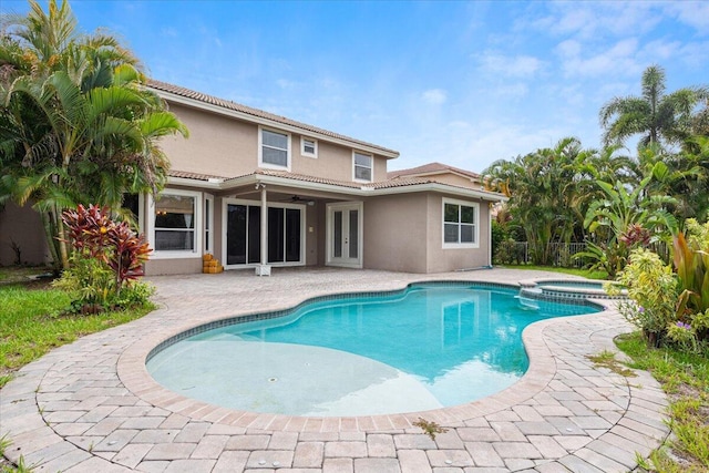 view of swimming pool with a patio area and an in ground hot tub