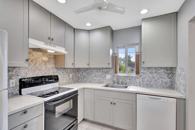 kitchen featuring gray cabinetry, white dishwasher, sink, decorative backsplash, and electric range oven