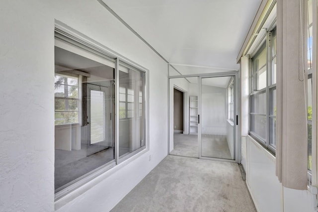 unfurnished sunroom with lofted ceiling