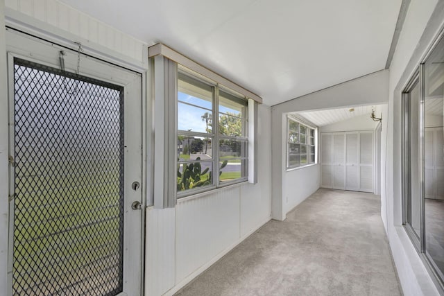 unfurnished sunroom with lofted ceiling