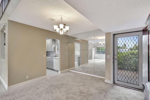 interior space featuring a textured ceiling, sink, and a chandelier