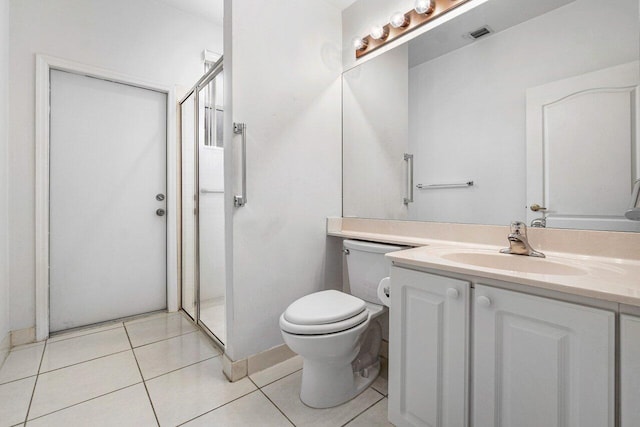 bathroom featuring toilet, a shower, tile patterned floors, and vanity