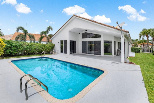 view of swimming pool featuring a patio and a yard