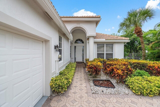 view of exterior entry with a garage