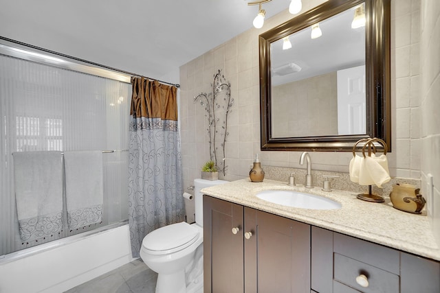 full bathroom with tile patterned floors, vanity, tile walls, toilet, and shower / bath combo