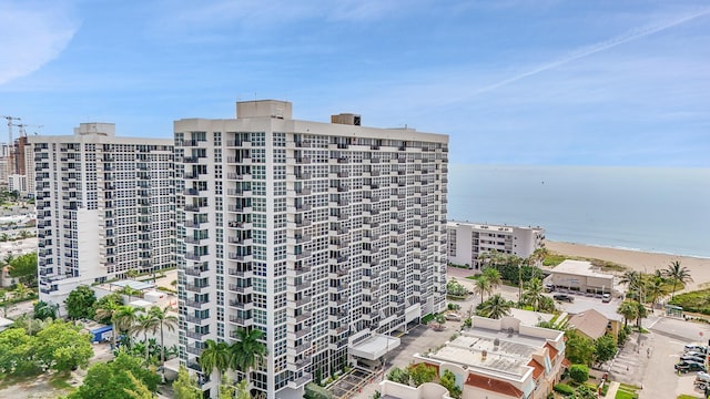 view of property with a view of the beach and a water view