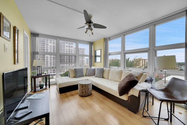 sunroom with ceiling fan and plenty of natural light