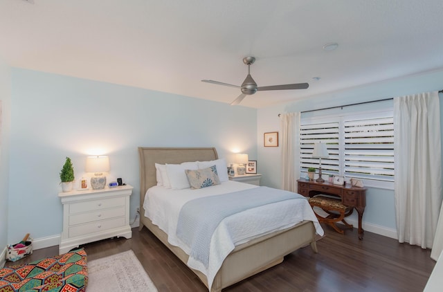 bedroom with dark hardwood / wood-style flooring and ceiling fan