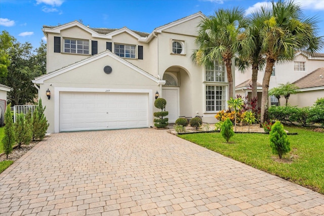 view of front of house with a garage and a front yard