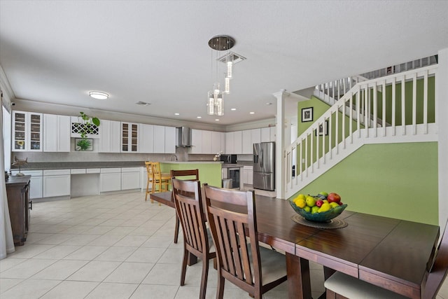 tiled dining room featuring decorative columns