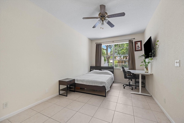 tiled bedroom featuring ceiling fan