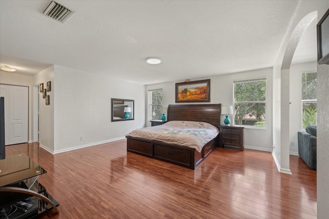 bedroom featuring wood-type flooring and a textured ceiling