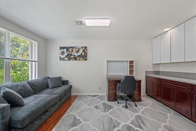 office area with light hardwood / wood-style floors