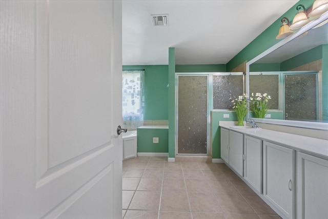 bathroom with plenty of natural light, tile patterned floors, vanity, and an enclosed shower