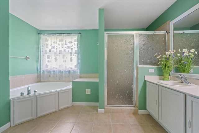 bathroom featuring vanity, tile patterned floors, and shower with separate bathtub