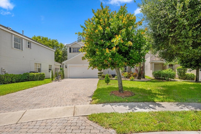 obstructed view of property featuring a garage and a front lawn