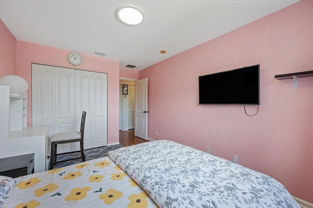 bedroom with a closet and dark wood-type flooring