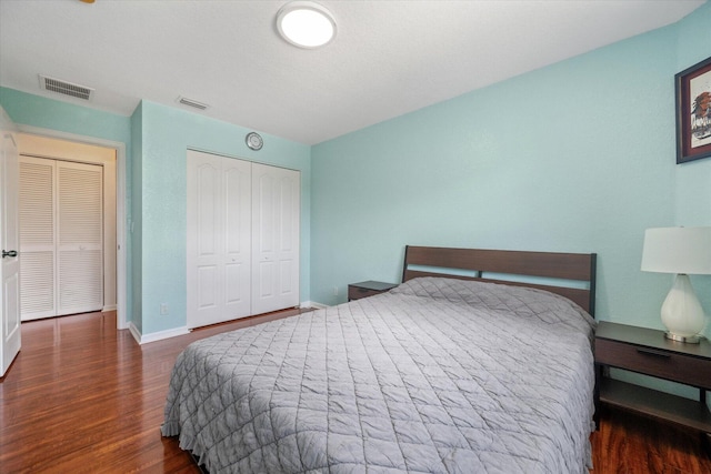 bedroom featuring dark wood-type flooring and a closet