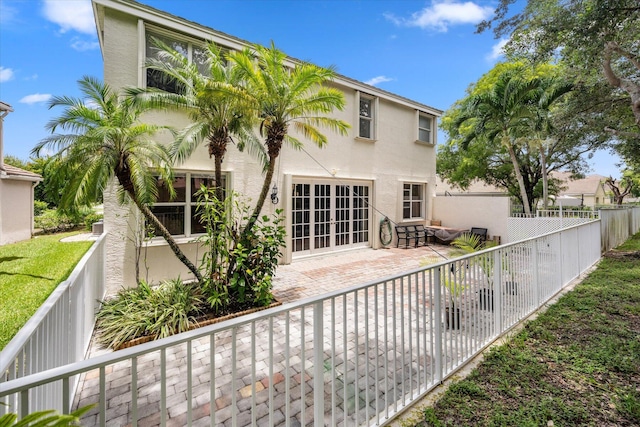 rear view of property featuring a patio area