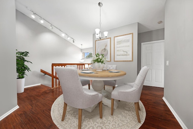 dining room featuring dark hardwood / wood-style floors and a notable chandelier