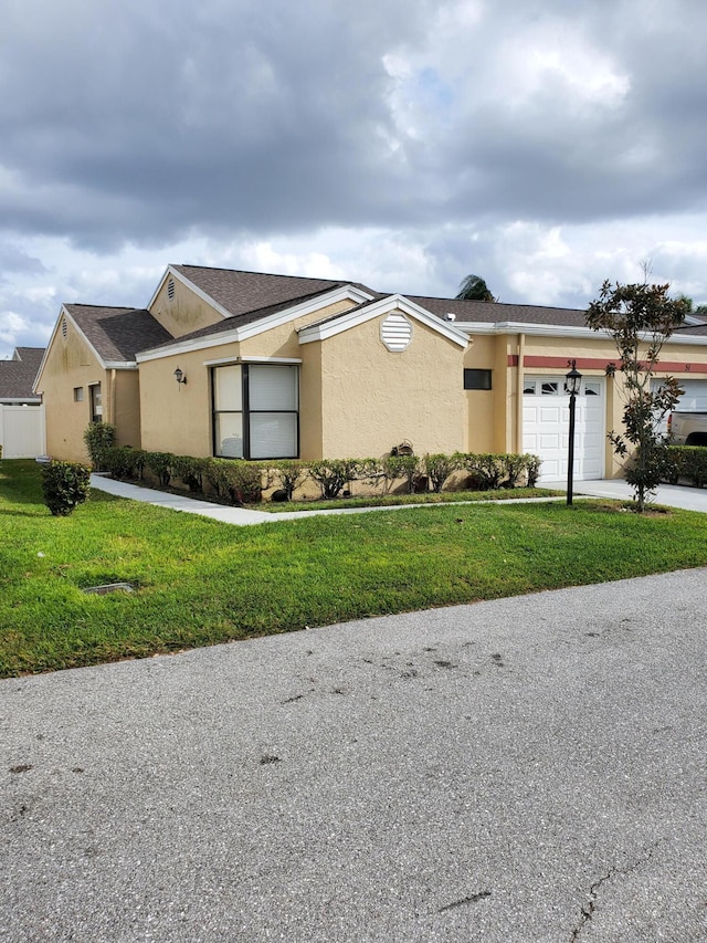 view of front of home with a garage and a front yard