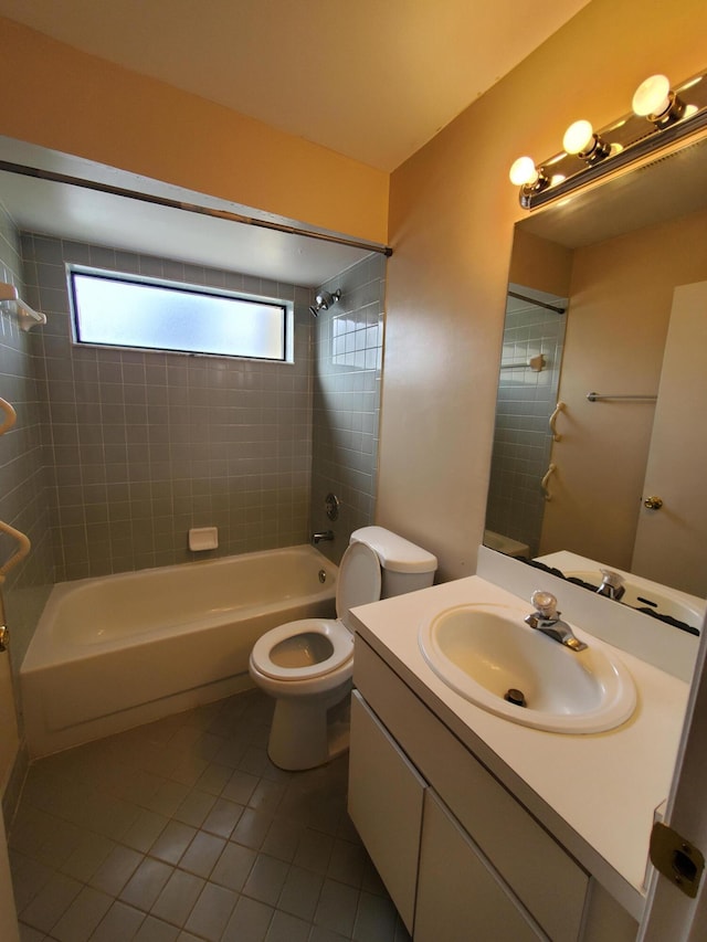 full bathroom with toilet, tiled shower / bath, tile patterned flooring, and vanity