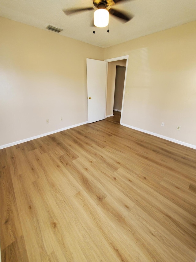 empty room featuring ceiling fan and light hardwood / wood-style floors