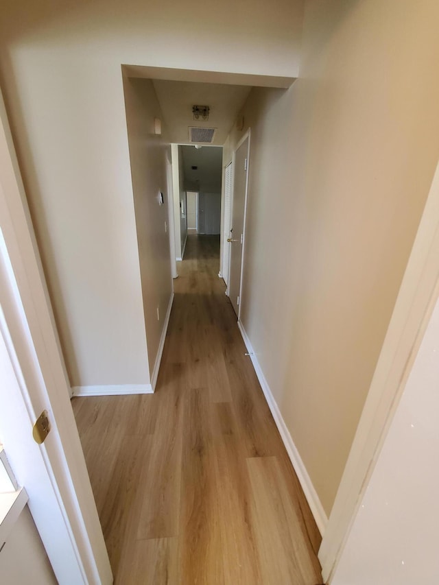 hallway with light wood-type flooring