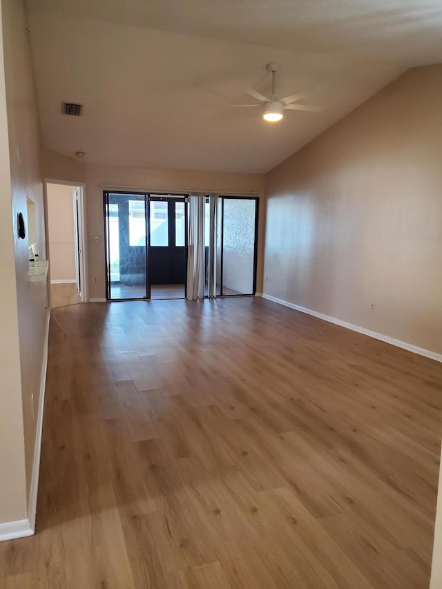 unfurnished room featuring ceiling fan, light hardwood / wood-style floors, and vaulted ceiling