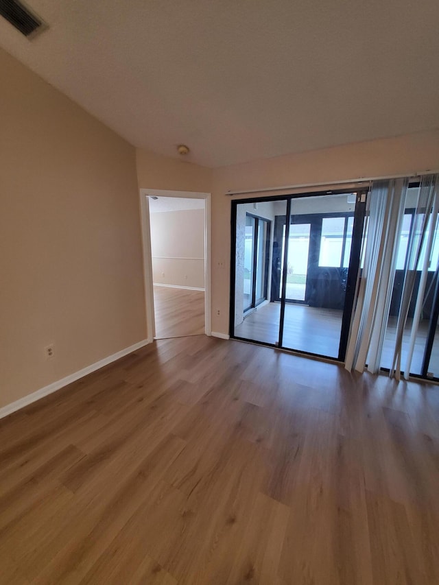 unfurnished room with wood-type flooring