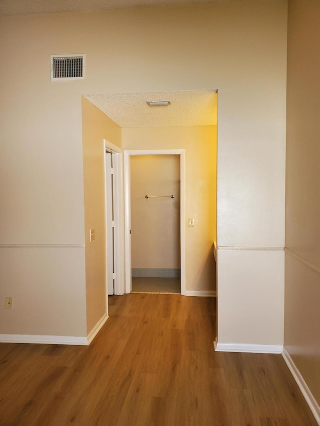 corridor featuring wood-type flooring