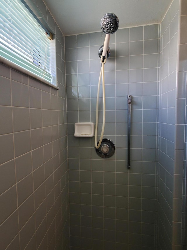 bathroom with tiled shower