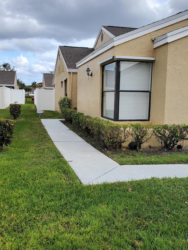 view of home's exterior featuring a lawn