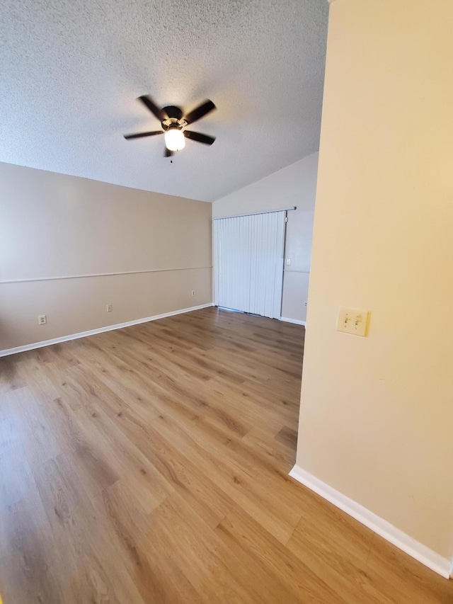 unfurnished room with ceiling fan, a textured ceiling, and light hardwood / wood-style floors