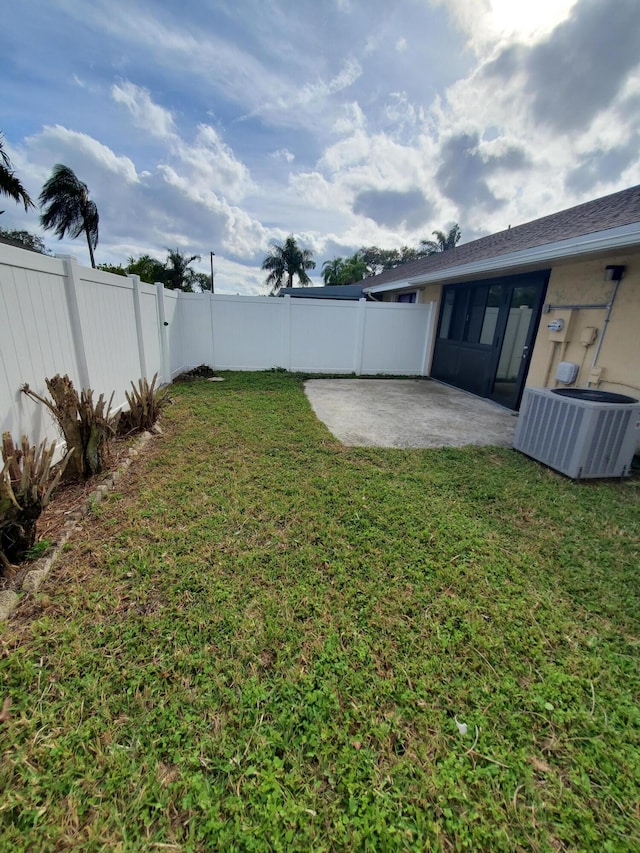 view of yard with cooling unit and a patio