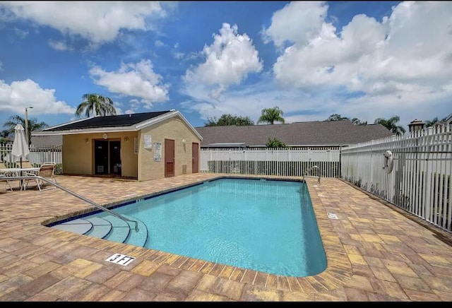 view of swimming pool featuring a patio area