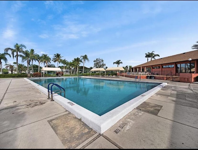 view of swimming pool with a patio