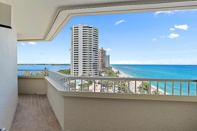 balcony with a beach view and a water view